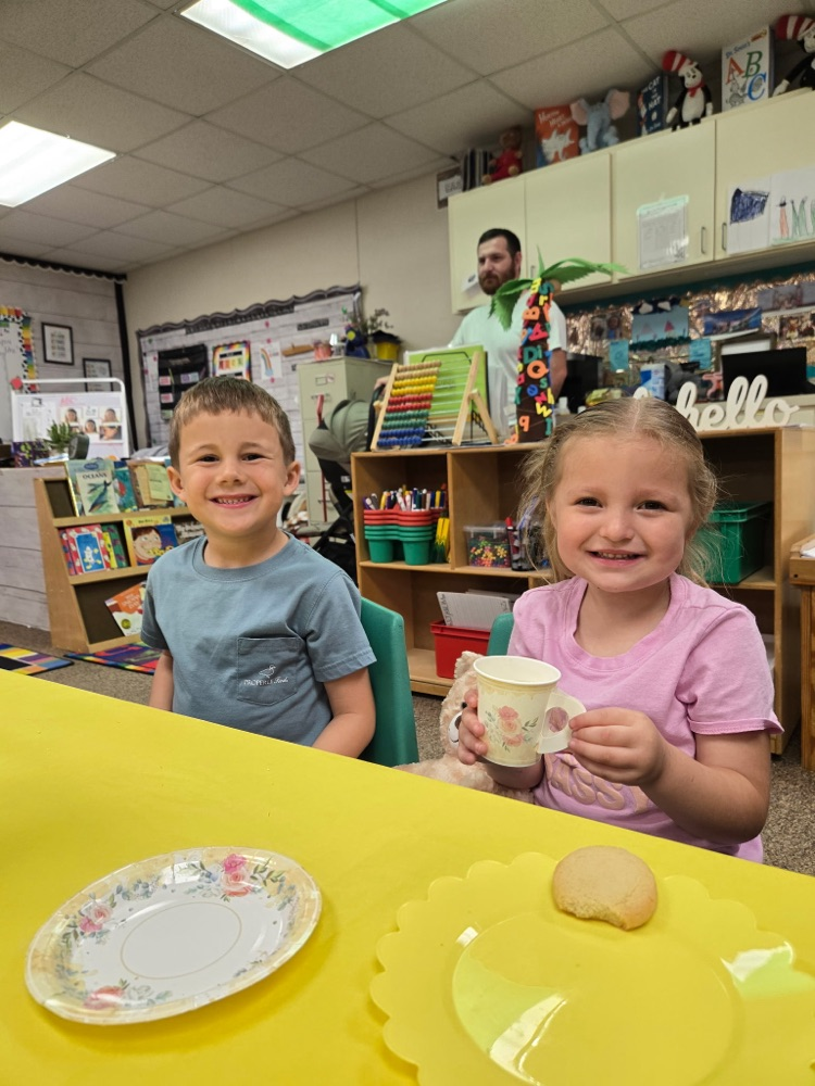 two kids with tea cups