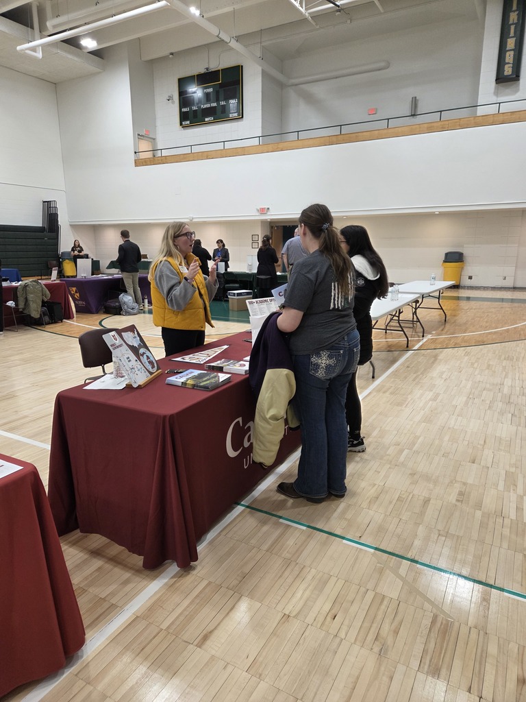 Students talking with a college recruiter.