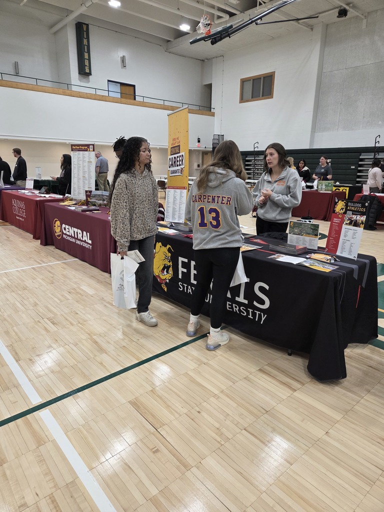 Students talking with a college recruiter.