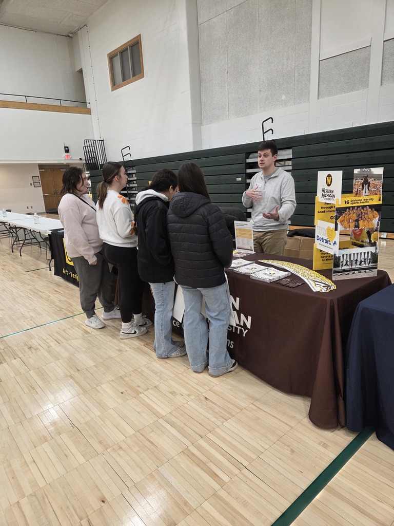 Students talking with a college recruiter.