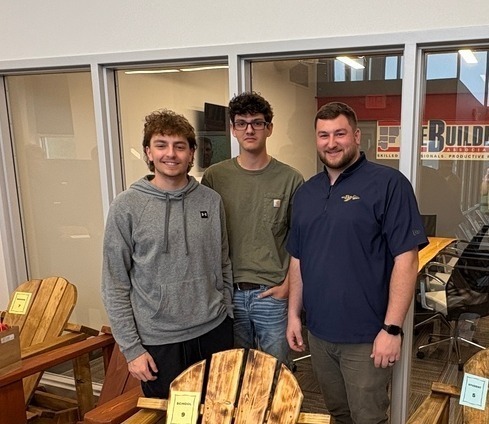 Building Trades Teacher and two students in front of chairs they build