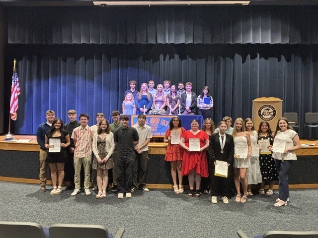 National Honor Society Members in front and on the stage