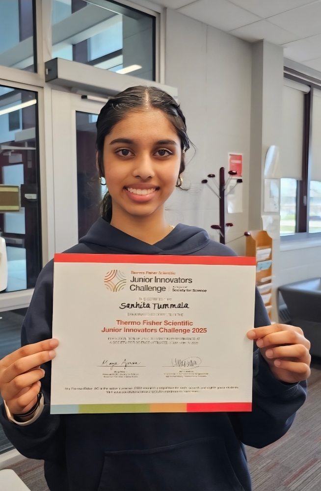 image of student Sanhita Tummala holding a certificate.