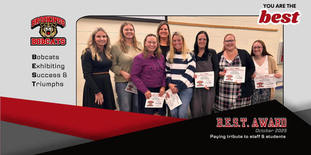 image of group of award winners with the superintendent. all are holding their award certificates and smiling.