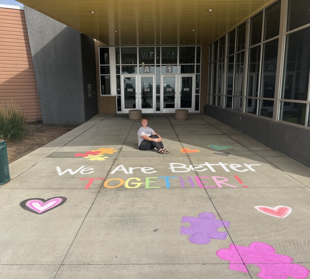 staff sitting in front of door of Dakota Prairie Elementary.