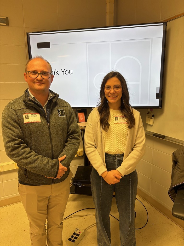 Image of Matthew Weiss and interior designer, Amber Engels in front of a presentation board. 