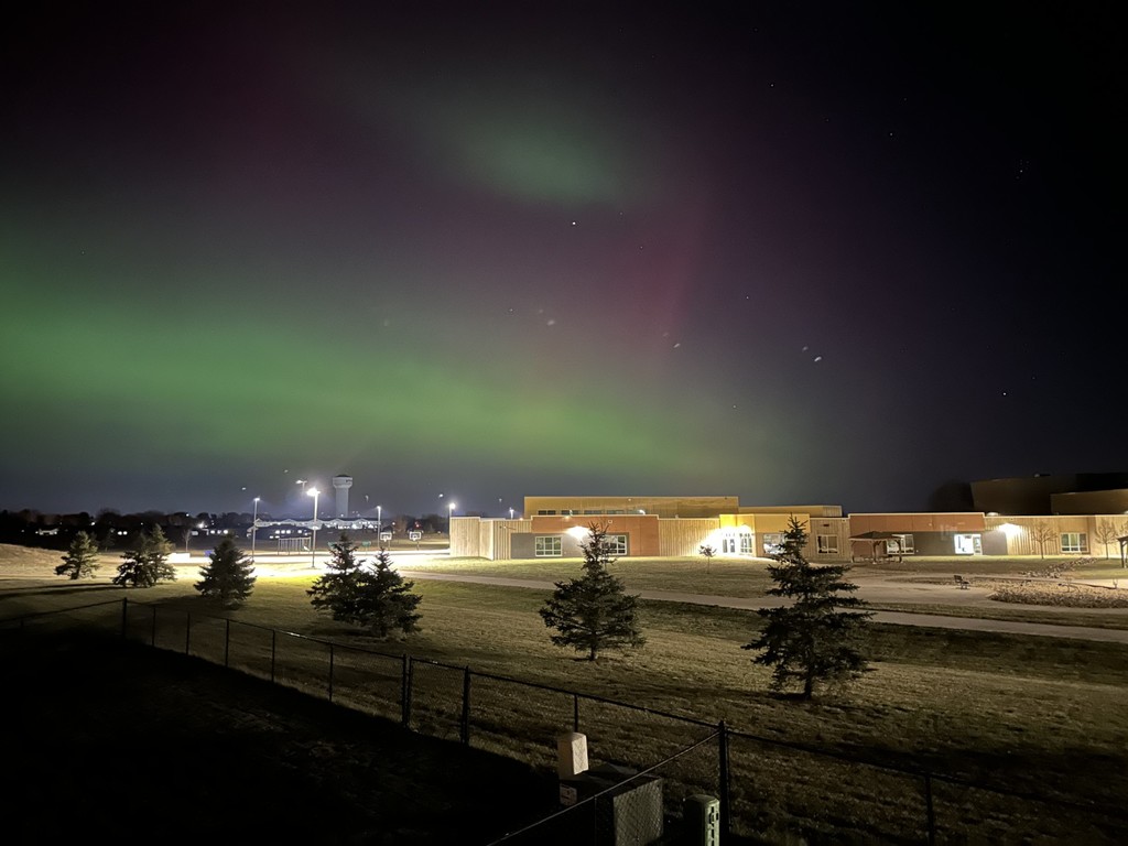 A wide-angle view of the northern lights over the dakota prairie elementary school. 