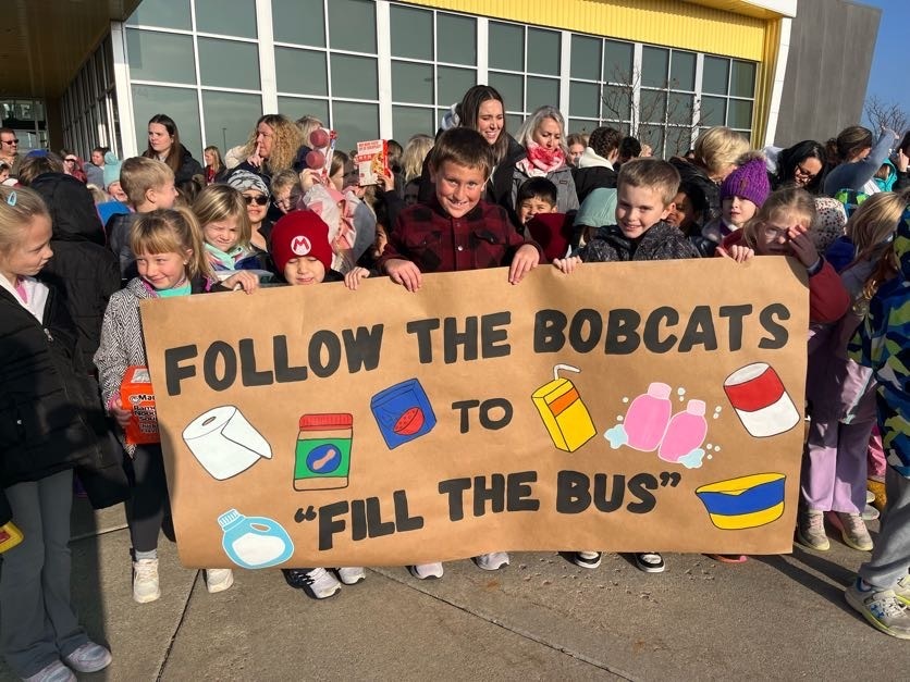 Students holding a sign.