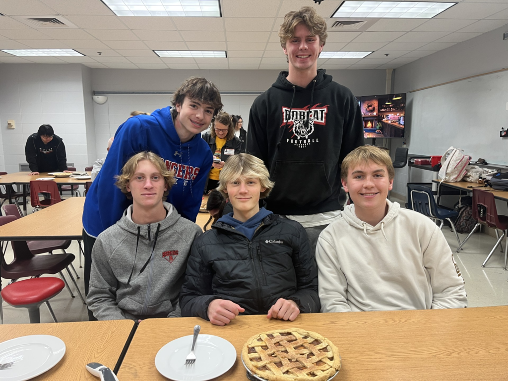 Students showing off their apple pie.