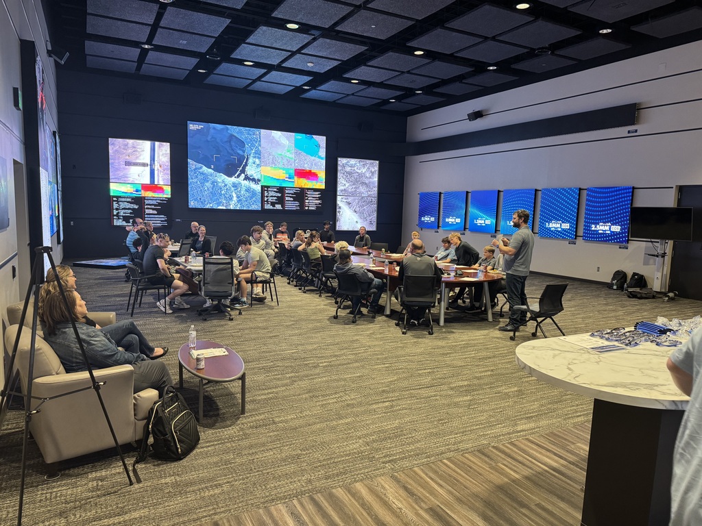 People sitting in a room listening to a speaker