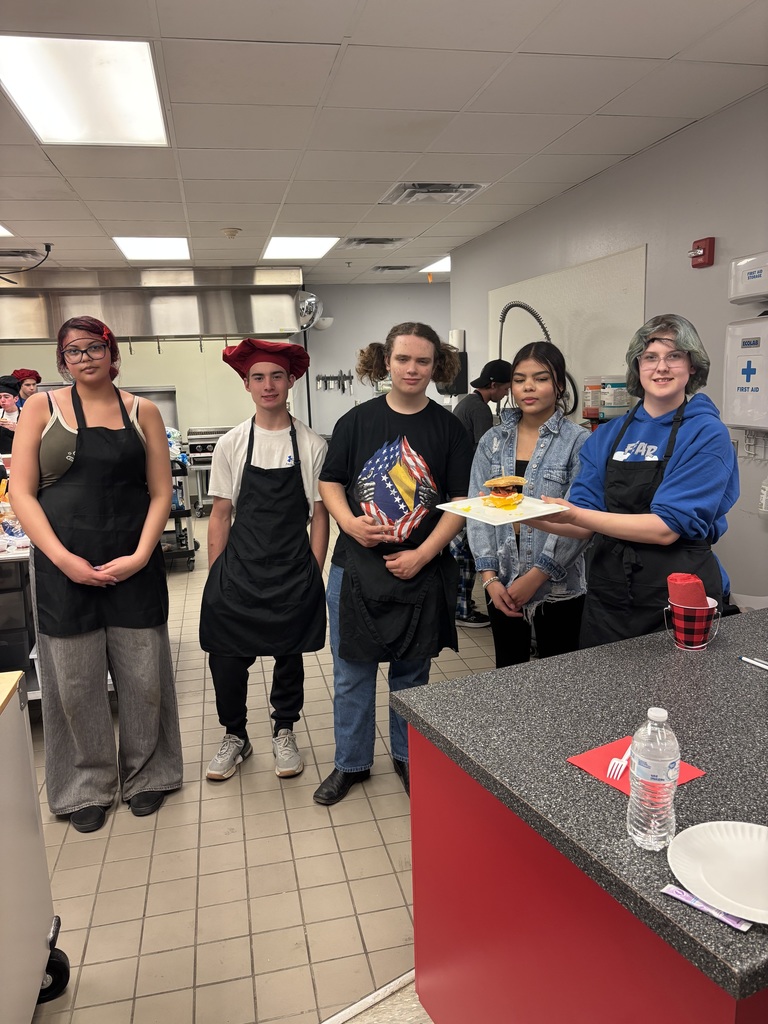 Students cooking hamburgers