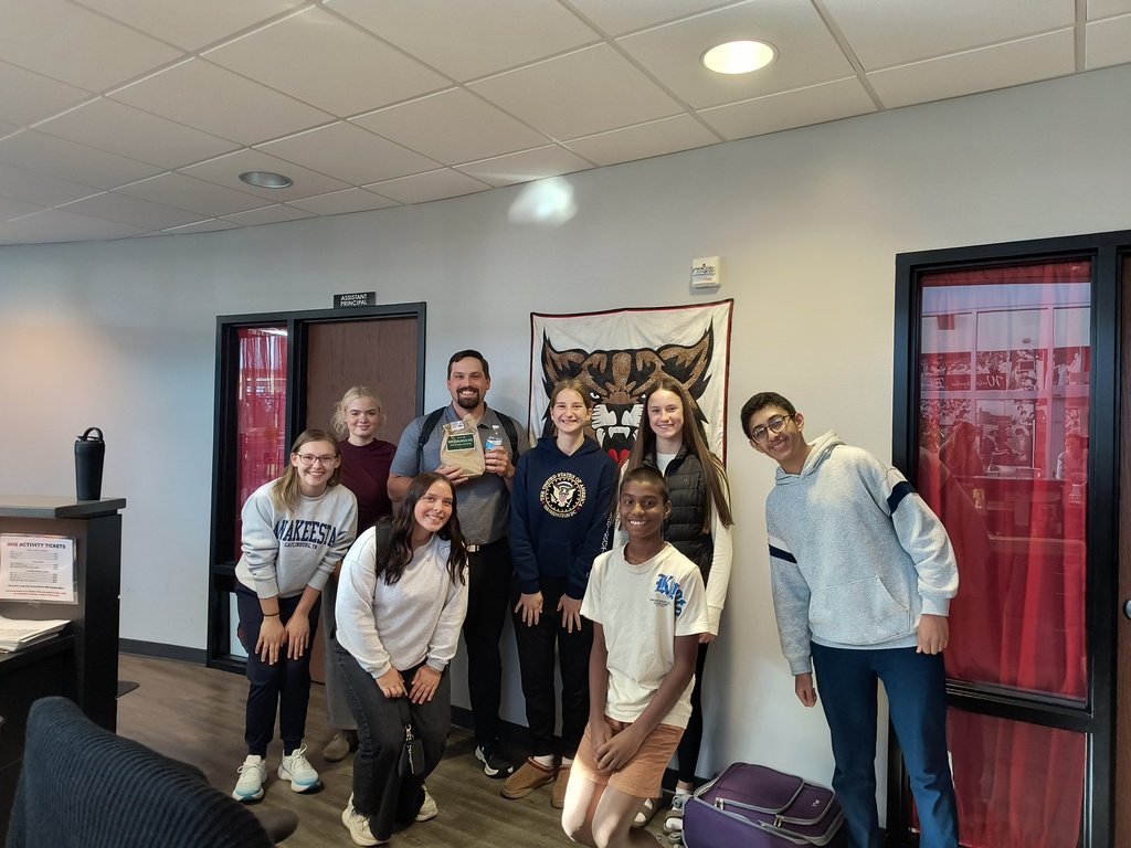 Students and Principal holding snack bag and water