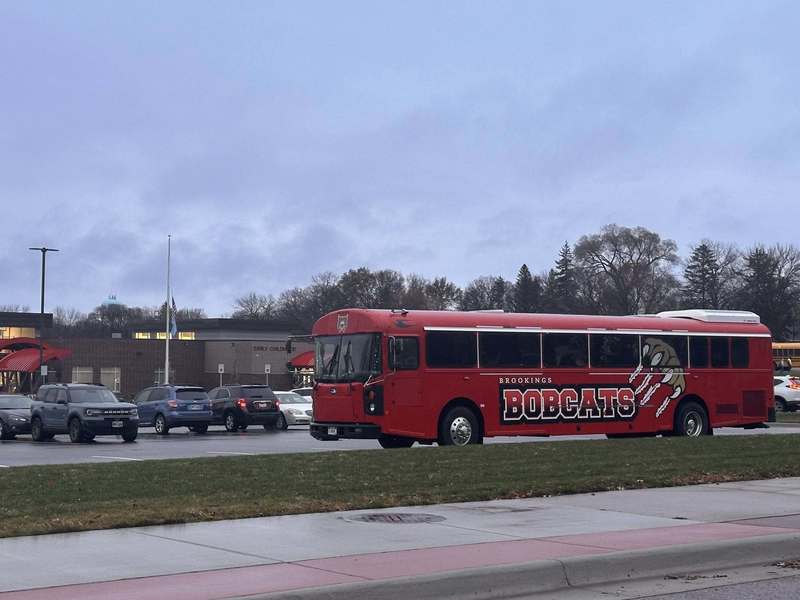 Bus parked in front of a school.