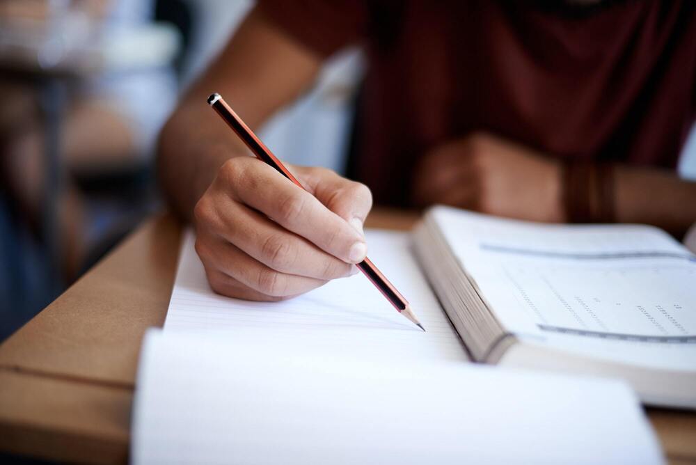 student working at desk doing homework