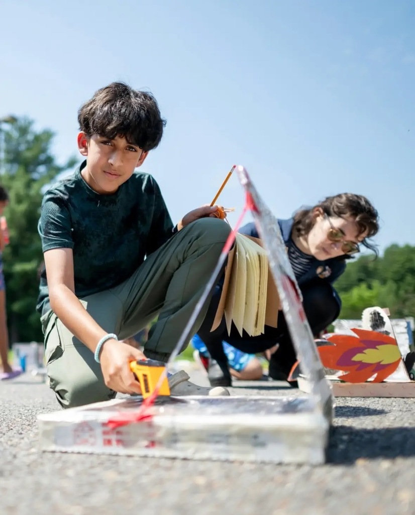 students working outside building solar ovens