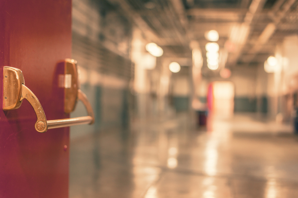 red door leading into a hallway of a school