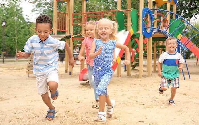students running on the playground at recess