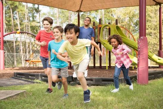 students running on the playground at recess