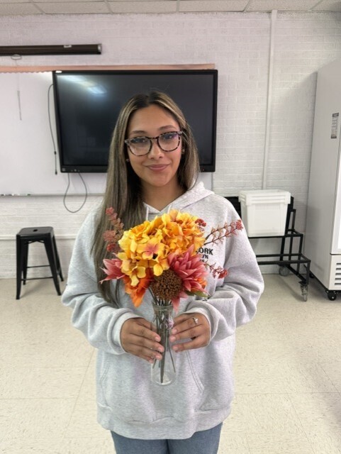student holding flowers