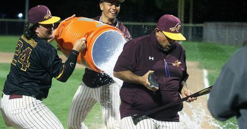 baseball players dumping gatorade on coach