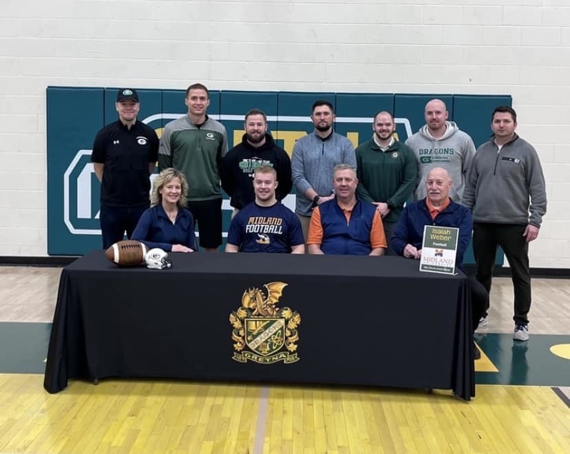 boys basketball team sitting in basketball gym