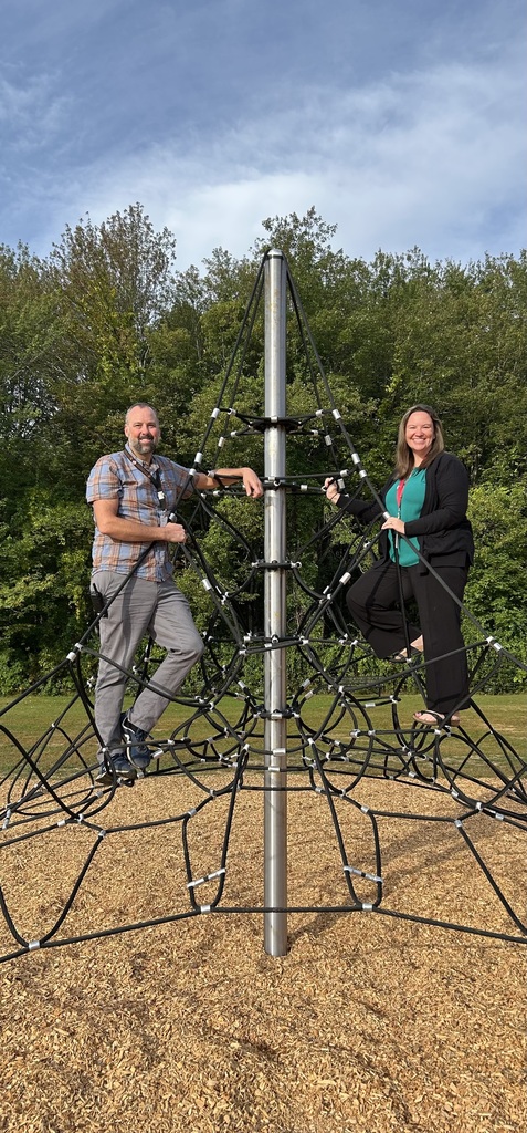 Principal & Assistant principal on climbing gym outside.
