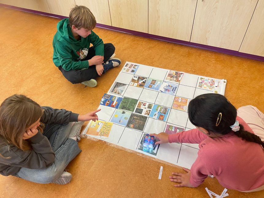 3 students coding the Bee-Bot