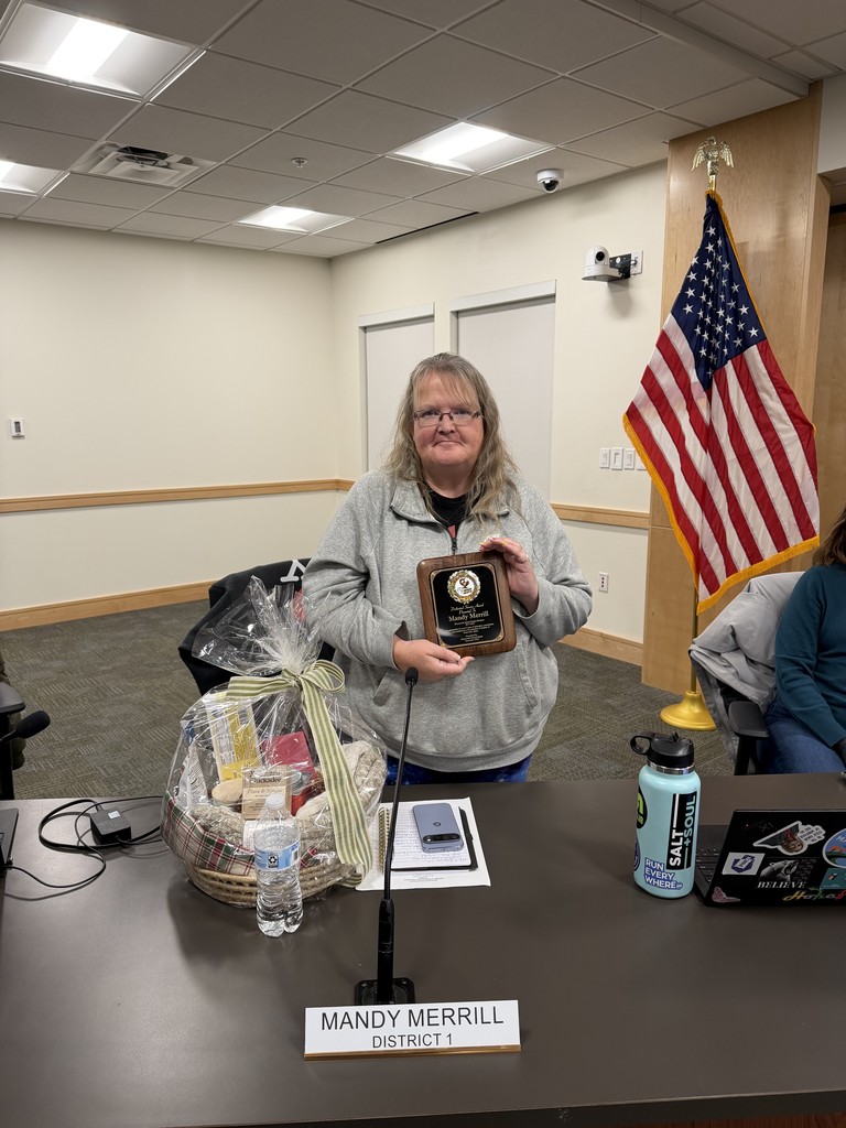 Mandy Merrill holding Outgoing School Board Member plaque