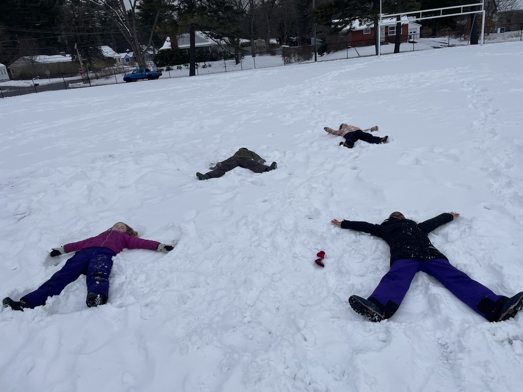 4 children making snow angels