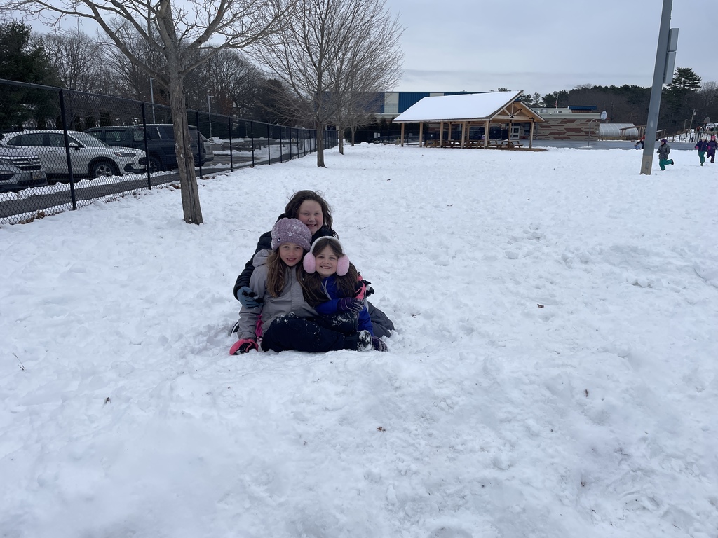 3 girls sitting together in the snow