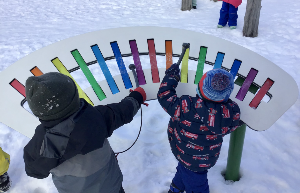 Kick off to Colors Week at KFS. Students playing a rainbow colored xylophone.