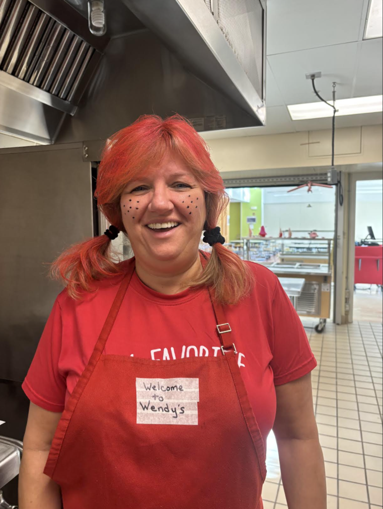 Red hair, shirt, and apron as the Wendy's icon