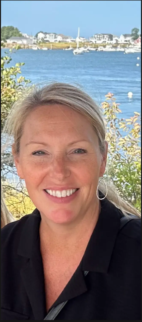 woman smiling with waterfront as backdrop