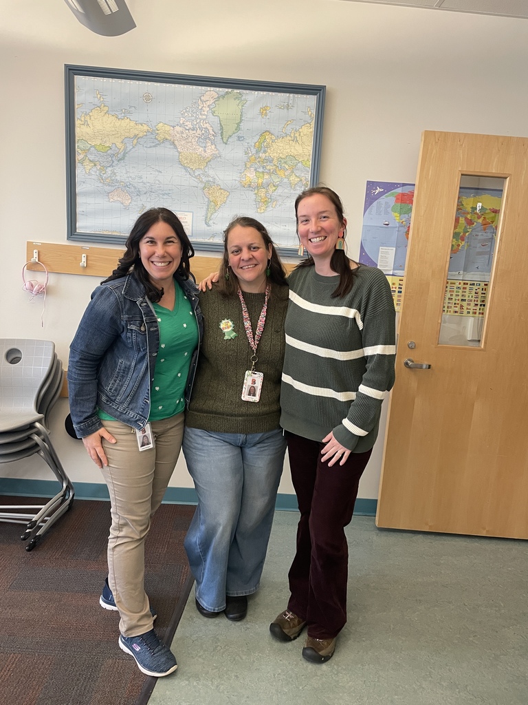 three teachers dressed in green