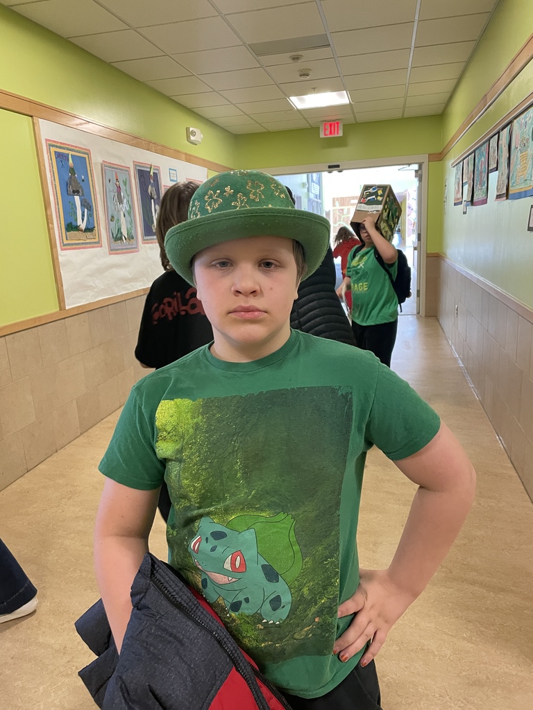 student wearing a green shirt and green hat