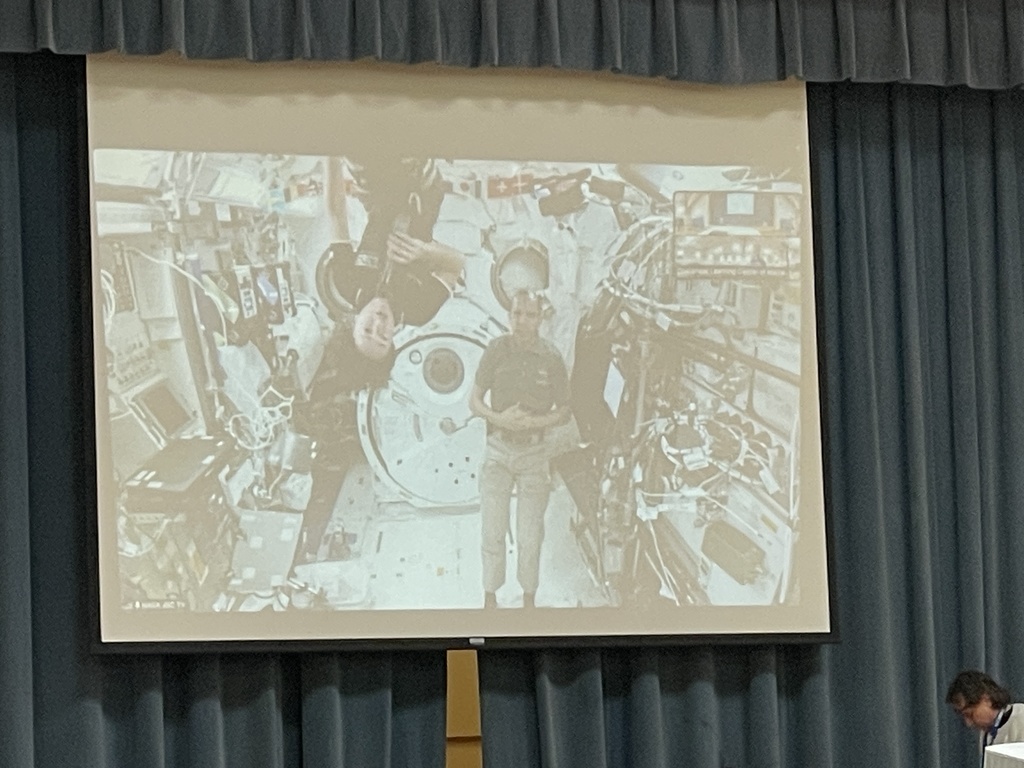 two astronauts on the projector floating around in space