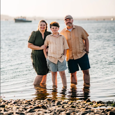 Erika and her family standing in shallow water.