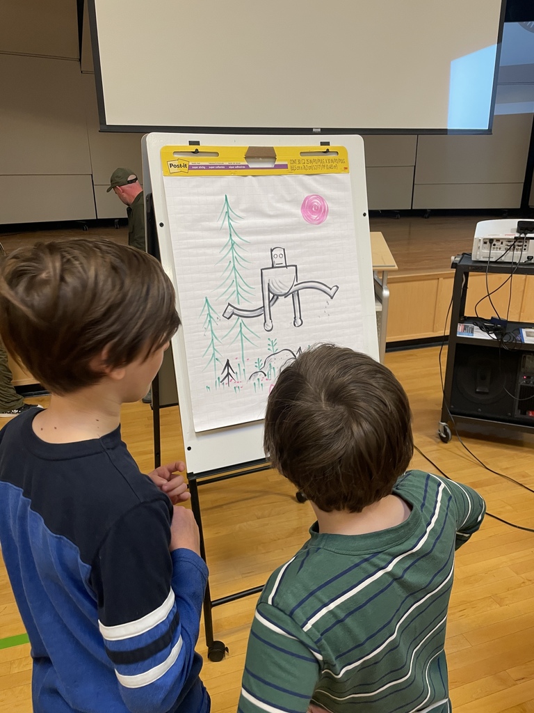 2 children looking at the sketch of the robot
