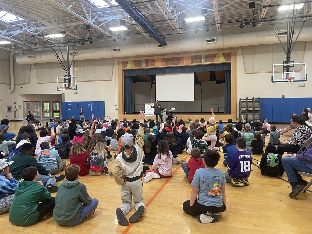 Many students raising hands to ask questions