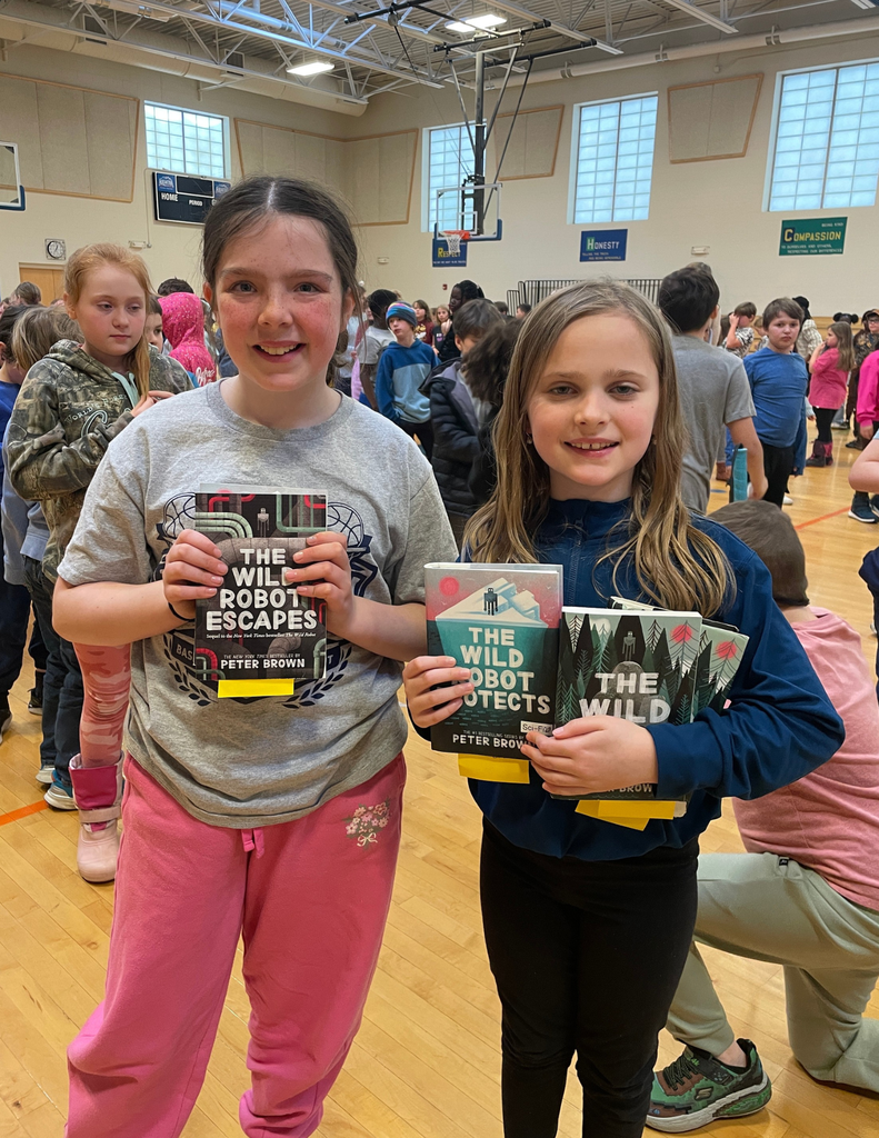 2 girls holding their copies of The Wild Robot