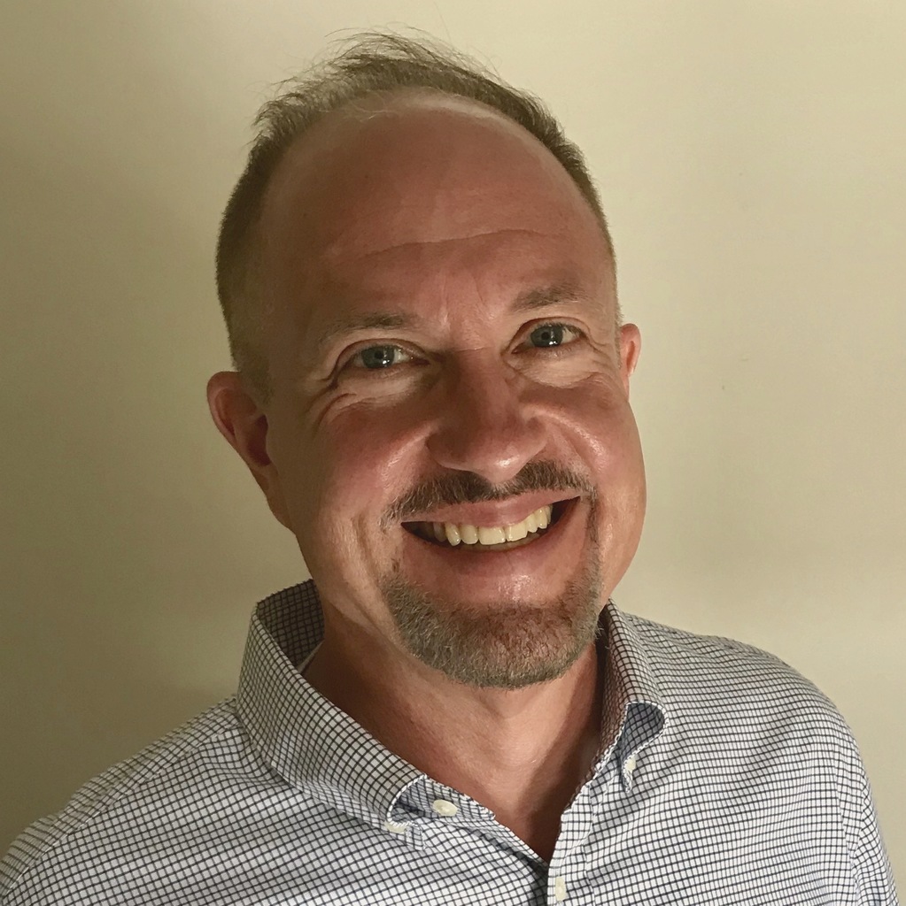 Man in plaid shirt smiling