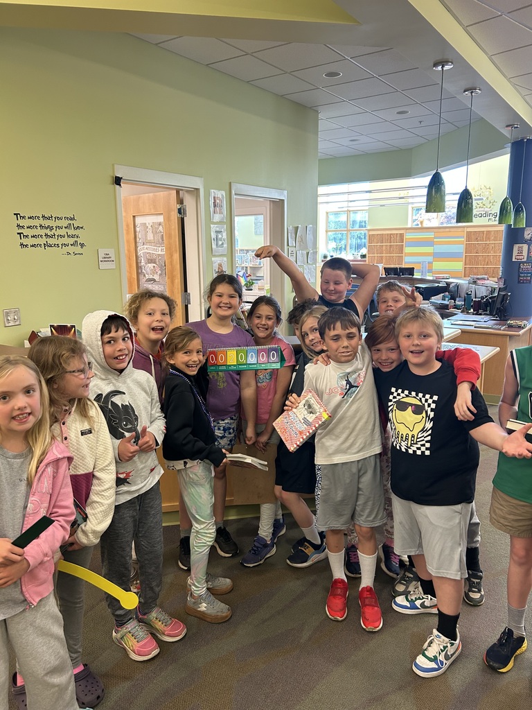students  celebrating their peer in the library