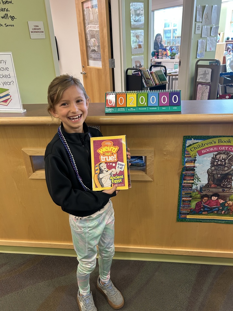student holding up the book Weird But True