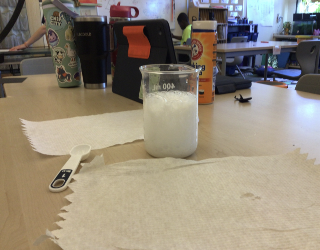 white substance in a science beaker