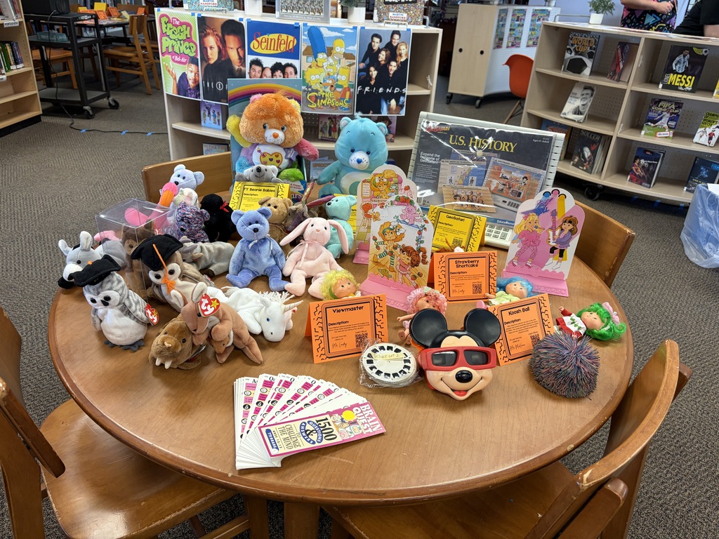 Table with TY beanie babies, Care Bears, and other toys from the 90's.