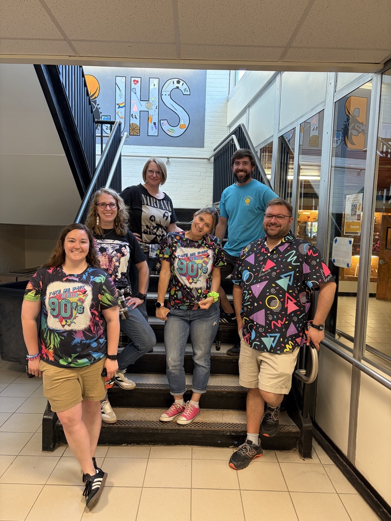 Team Bailey Teachers posing on the stairs wearing 90's clothing.
