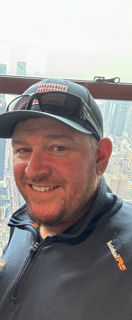 Man in a baseball hat smiling
