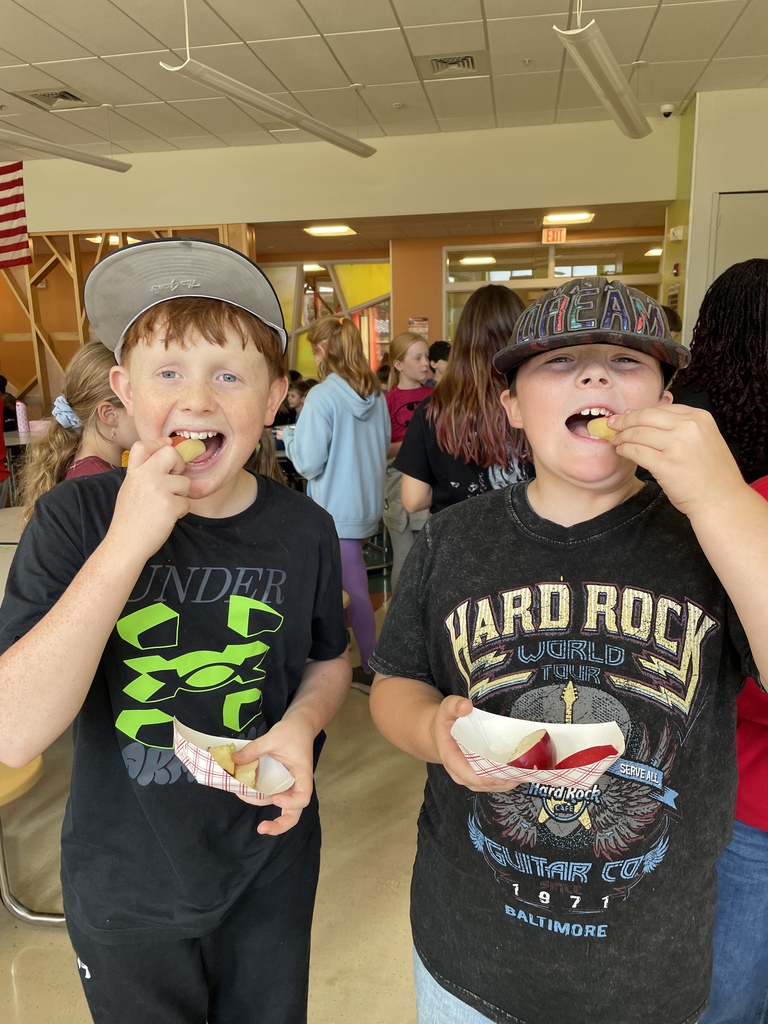 two boys eating apples