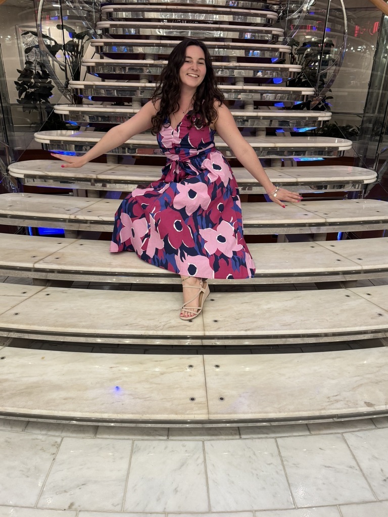 woman sitting on stairs in a floral dress
