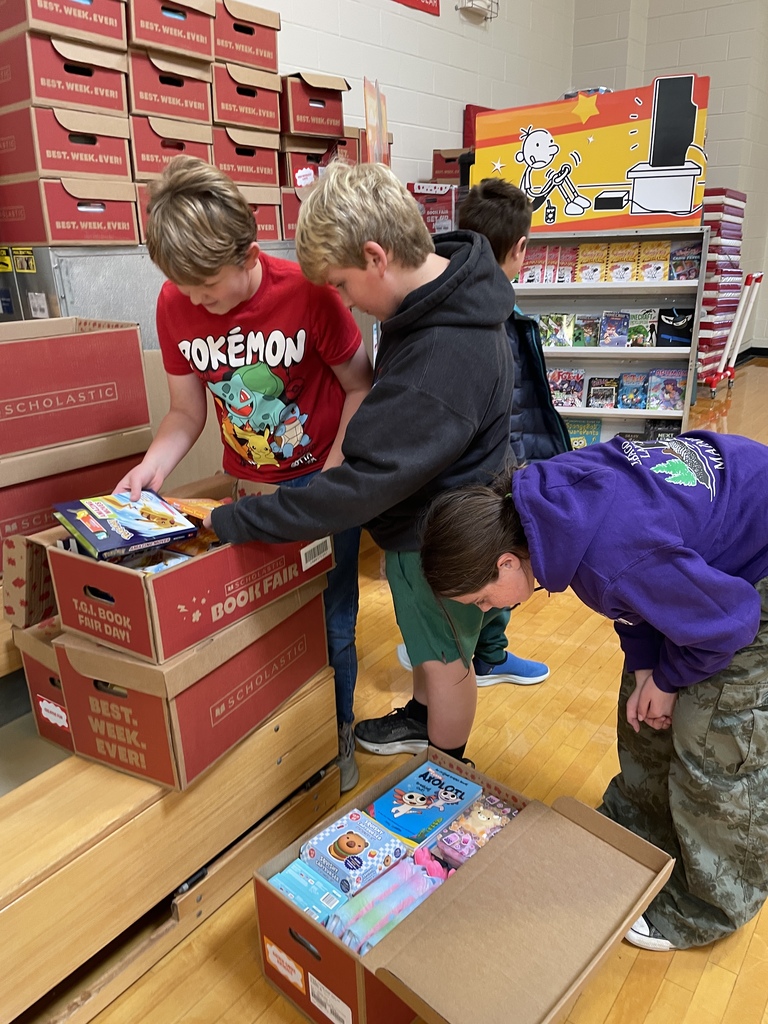 students looking at books in boxes